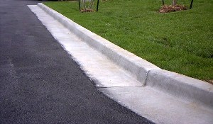 Concrete curb & gutter along edge of driveway