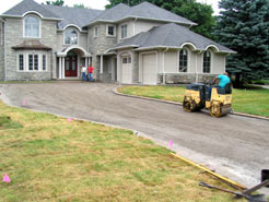 Using a twin drum roller to compact the driveway foundation layer
